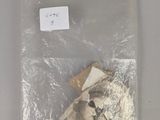 a teddy bear in a plastic bag on a table