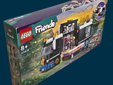 a box of lego friends train set on a blue background
