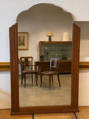 a mirror that is sitting on the floor in front of a table