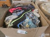 a cardboard box full of clothes that is sitting on a table