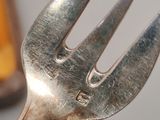 a fork that is sitting next to a bottle of beer
