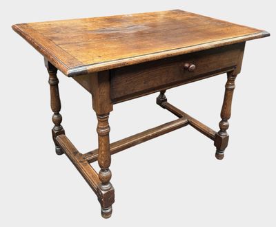 an old wooden table with a drawer on top of it