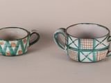 two cups sitting next to each other on a table