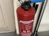 a fire extinguisor sitting on the floor next to a door