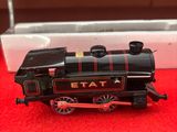 un petit train assis sur un tapis rouge
