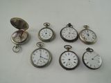 several different types of pocket watches sitting on top of a table