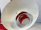 a red and white light that is on top of a table