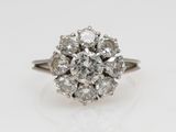 a close up of a diamond ring on a white surface