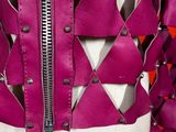 a close up of a mannequin jacket with zippers on it