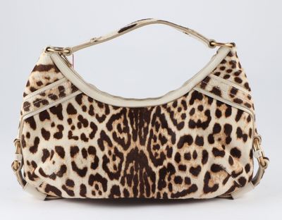 the leopard print purse is on display on a white surface