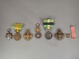 several medals and medals are arranged on a white surface