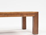 a wooden bench that is sitting on a white surface