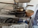 a pile of dishes and pans sitting on the floor