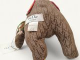 a stuffed animal that has a tag on it ' s neck