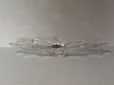 a glass bowl with a bird on it on a table