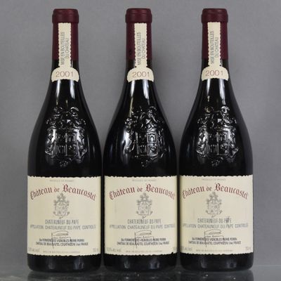 three bottles of red wine are lined up on a table