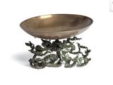a metal bowl with a dragon design on it