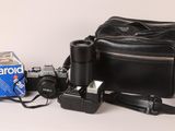 a camera, a camera case, a camera and a box of polaroid