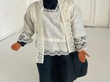 a figurine of a woman wearing a hat and dress