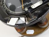 a close up of a clock on a stand on a table