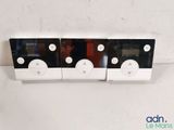 two mp3 players are sitting on a wall with a man in the background