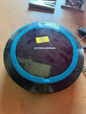 a clock that is on a table next to a cell phone