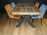 a wooden table with chairs around it on a hard wood floor
