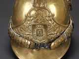 a gold helmet with a coat of arms on it