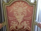 a red and white chair with a floral design on it