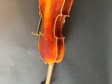 an old violin hanging on the wall in a room