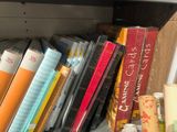 many books that are on a shelf in the room