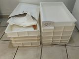 two plastic containers sitting next to each other on the floor