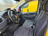 a yellow car with two seats and a steering wheel