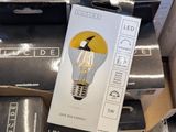 a box with a light bulb on top of a pile of other boxes