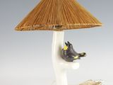 a lamp that has a bird on top of it