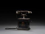 an old fashioned telephone on a black background with a black background