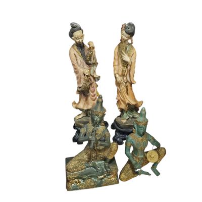 pair of chinese figurines of a man and a woman with a frog