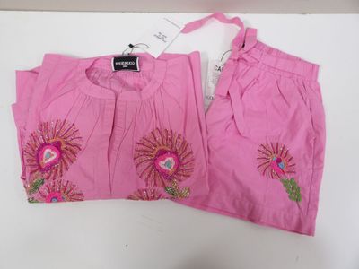 pair of pink pants with pink flowers on them on a white table