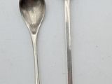 two spoons and a spoon on a white surface