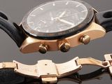 an image of a close up of a watch on a black surface