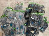 many bags of shoes that have been wrapped in plastic