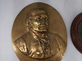 a gold plaque with a picture of a man on it