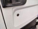 a close up of a white truck door with a screw on it