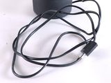 a black speaker that is connected to a charger