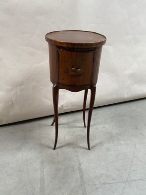 a small wooden table with a drawer on top of it