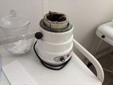 a blender sitting on top of a counter next to a bowl