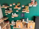 many shelves with bottles and containers on them in a store