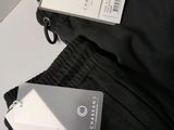 two tags attached to the back of a black jacket