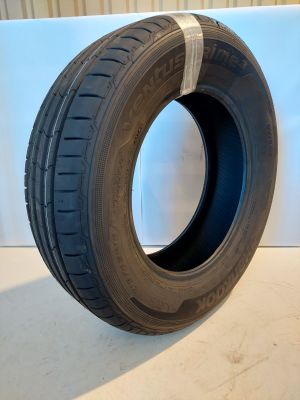 a close up of a tire on a table with a white background