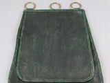 green leather purse with two rings hanging from it ' s sides